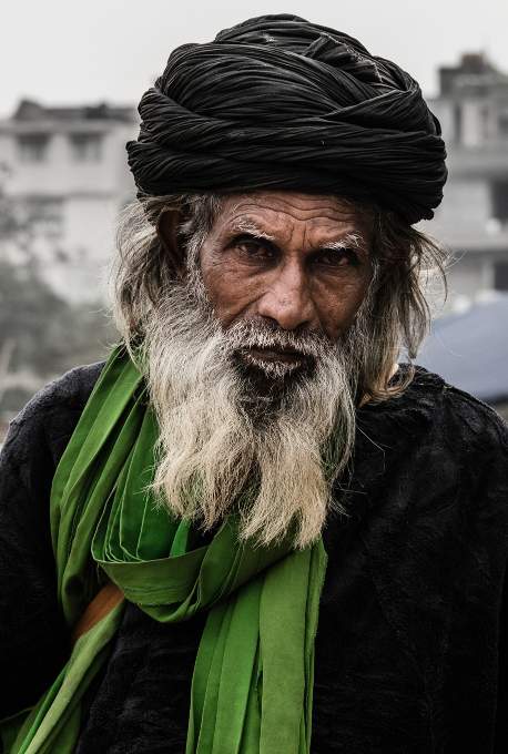 An old Delhi citizen having a direct eye contact with the camera.