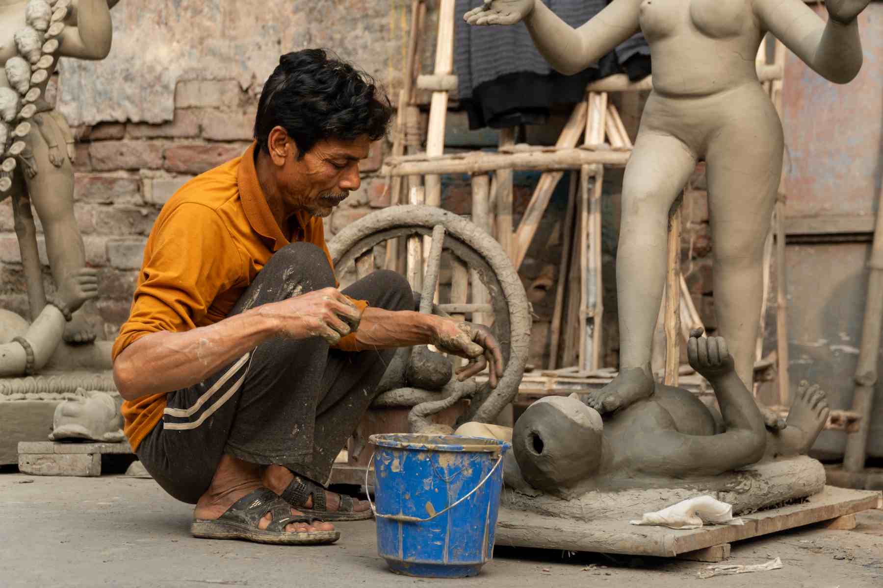 man making arts with clay