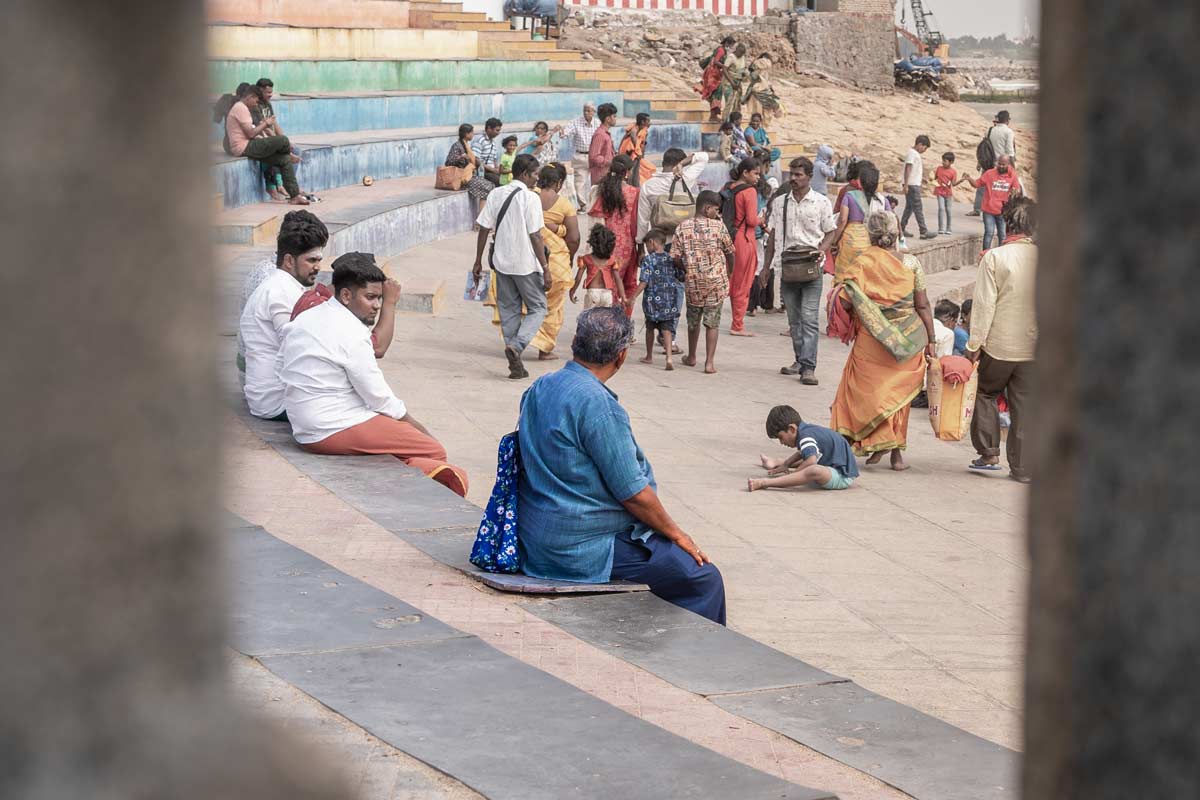 an old man is watching towards the crowd