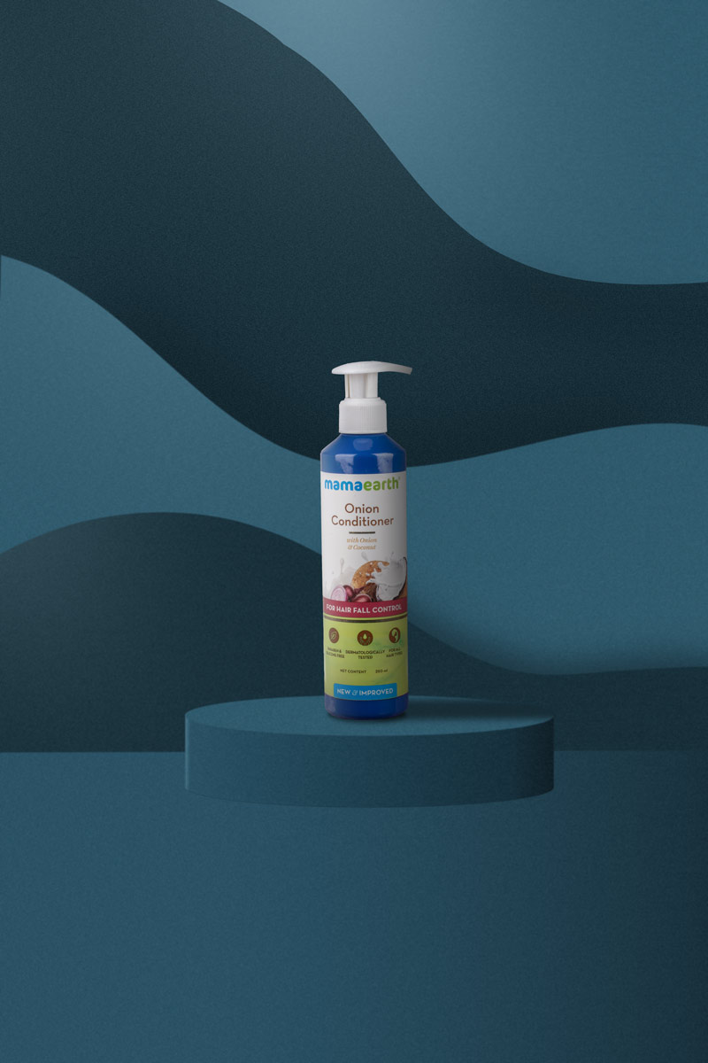big bottle onion conditioner in a blue background
