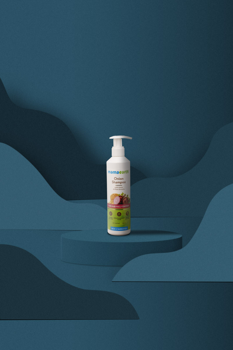 big bottle onion shampoo in a blue background