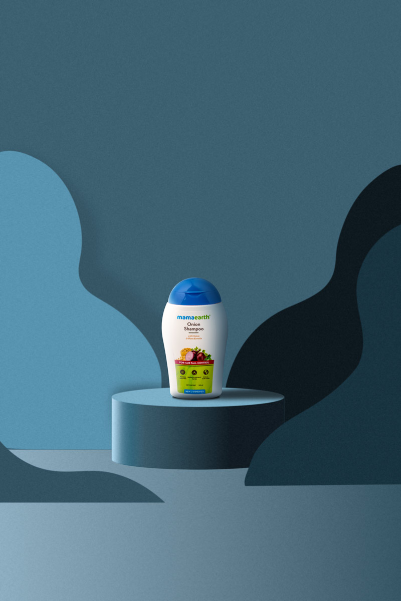 small bottle onion shampoo in a blue background