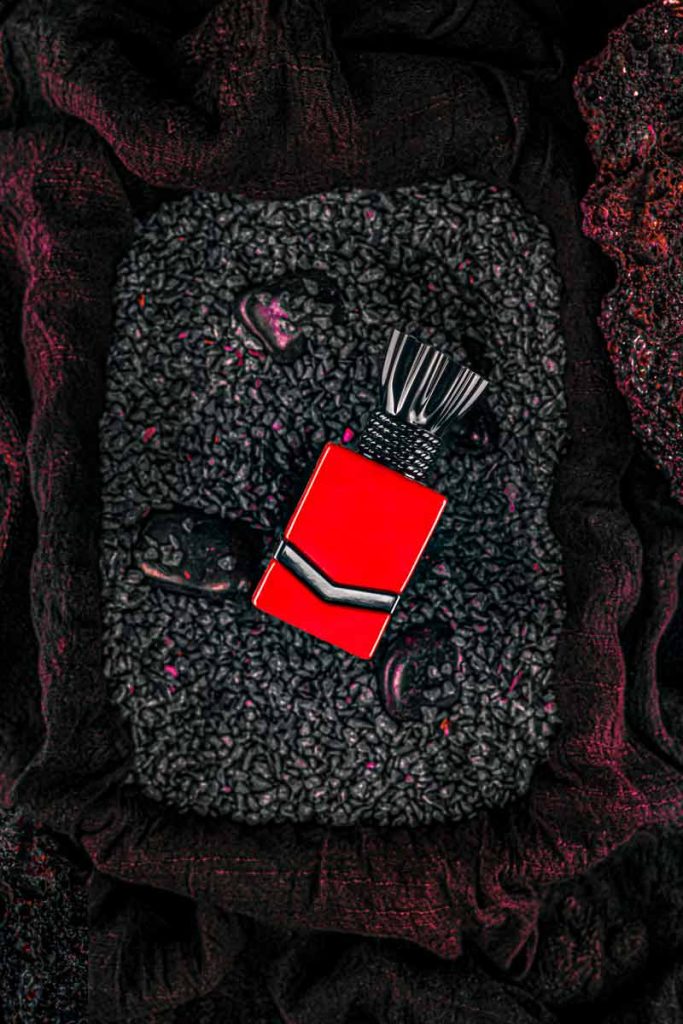 red perfume on the stone